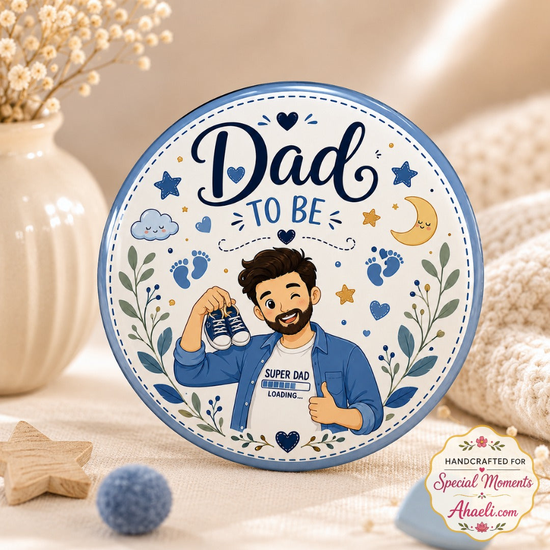 Dad-to-Be Baby Shower Badge featuring a cute father-to-be holding baby shoes with Super Dad Loading illustration on a premium 58mm glossy round metal keepsake pin.