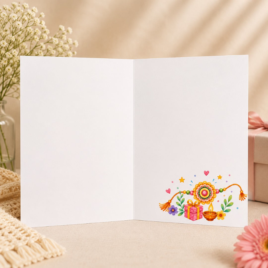 Inside view of Happy Raksha Bandhan greeting card with a blank interior for handwritten or personalized messages, featuring a watercolor rakhi, diya, flowers, and gift illustration.