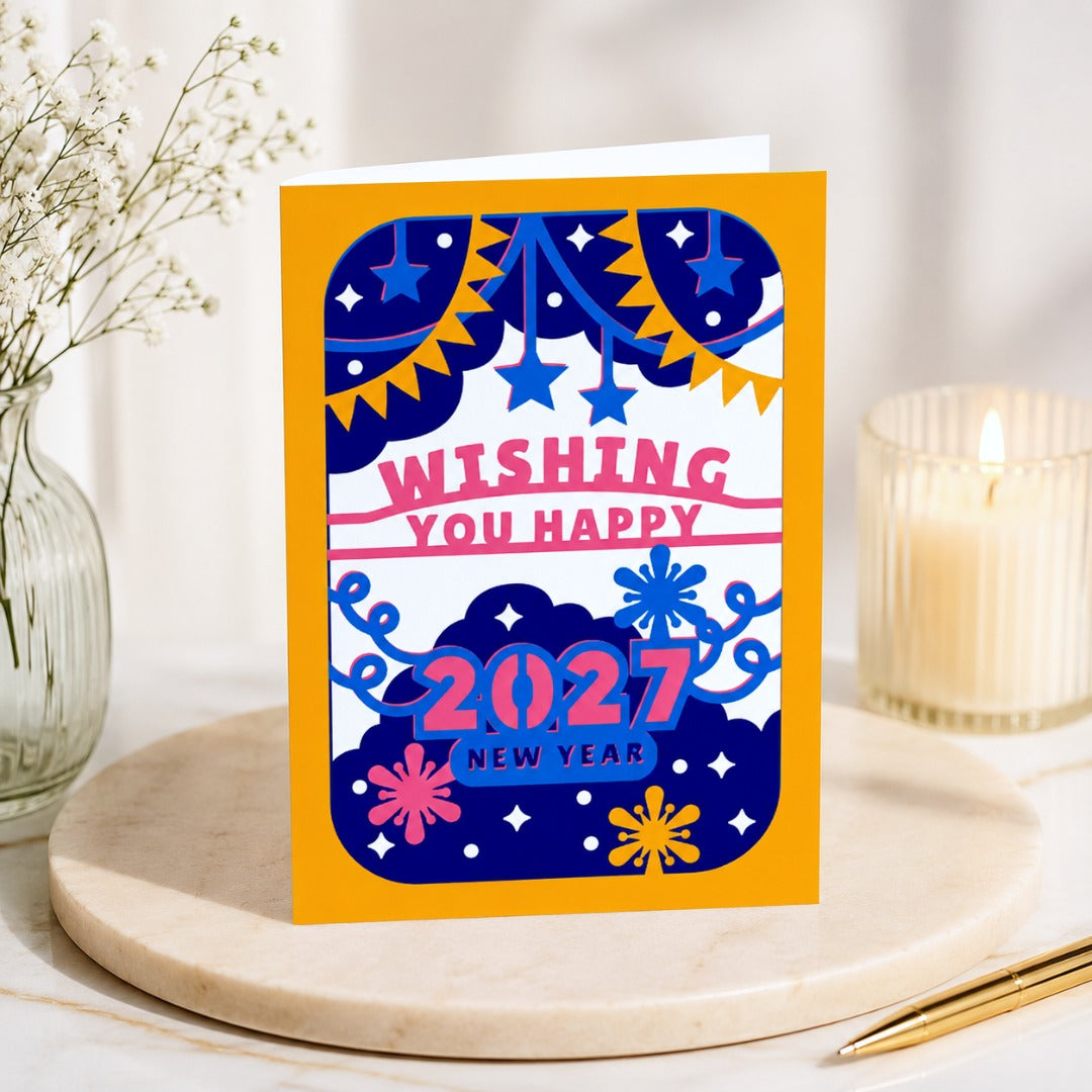 Premium standing mockup of a colorful 2027 Happy New Year greeting card displayed on a marble pedestal with elegant home decor.