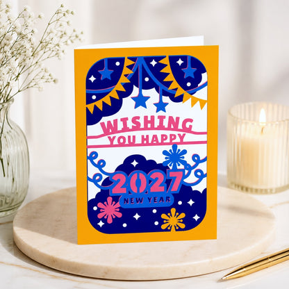 Premium standing mockup of a colorful 2027 Happy New Year greeting card displayed on a marble pedestal with elegant home decor.