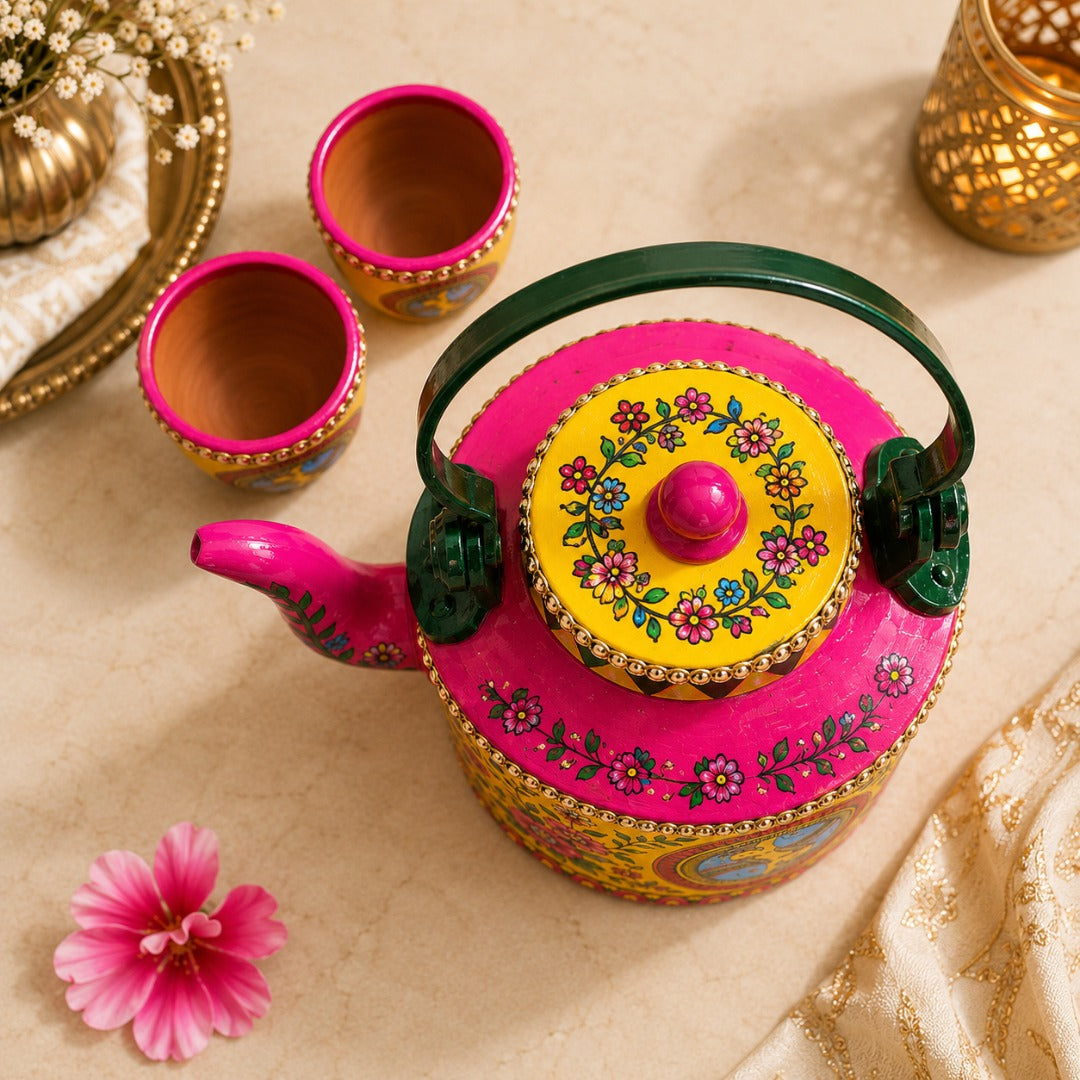 Top view of Ahaeli hand-painted Madhubani art kettle with matching tea cups featuring vibrant floral folk art in a modern traditional design.