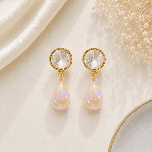 Elegant crystal pearl drop earrings for women featuring round crystal studs and iridescent teardrop faux pearl drops with a gold-tone finish.