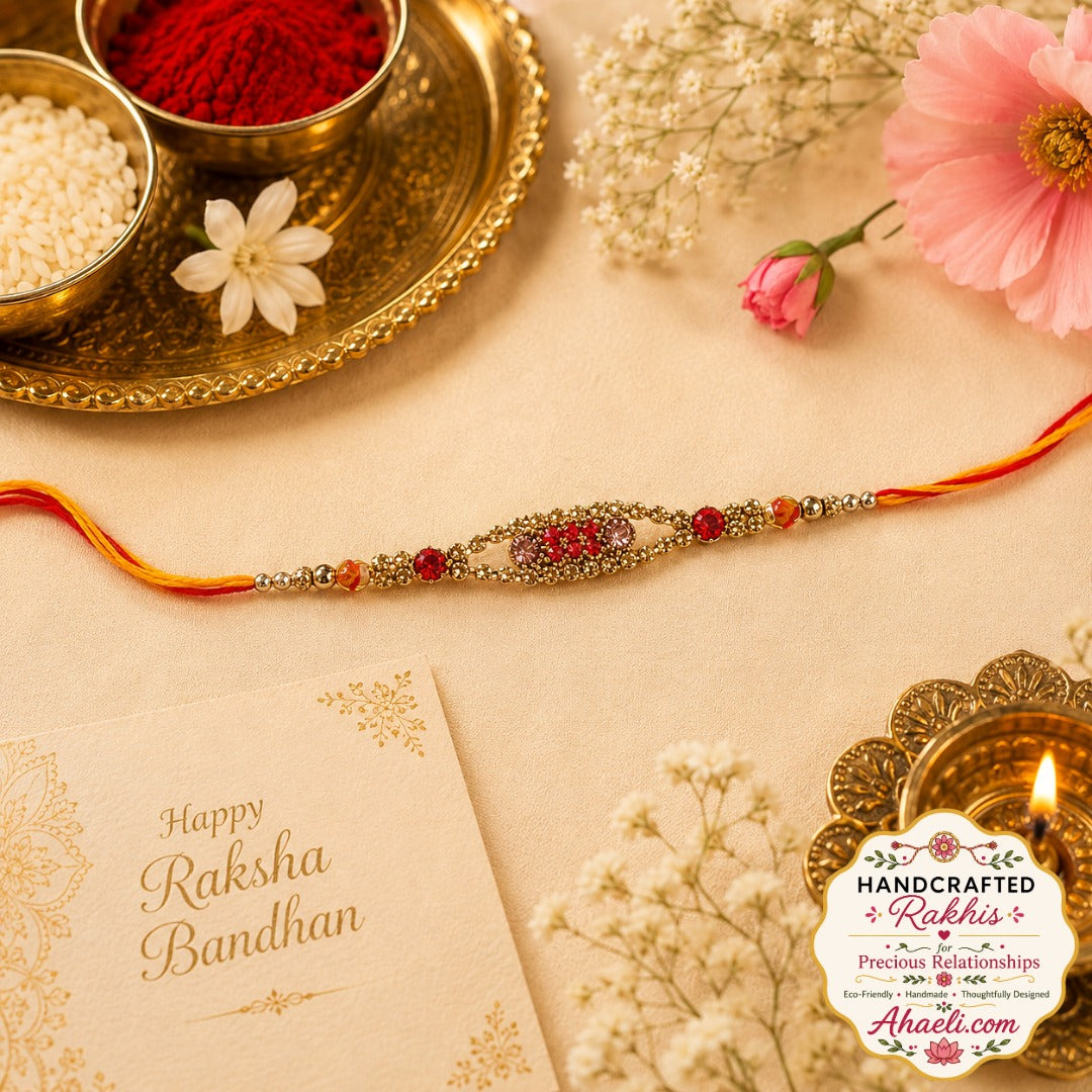 Handcrafted red stone designer rakhi with decorative metal detailing and festive thread