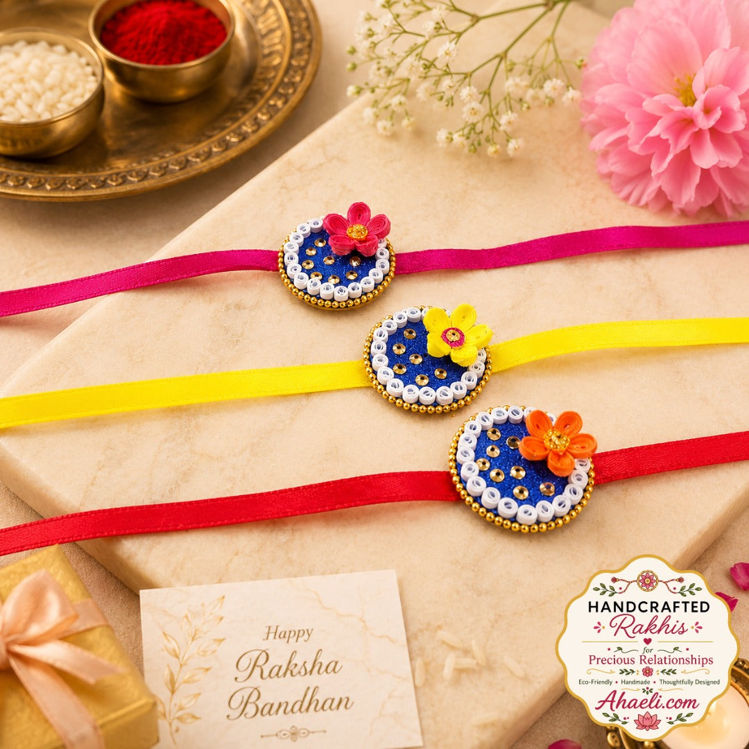 Handmade paper quilled Jewel Bloom Rakhi featuring blue base, floral design, and decorative embellishments for Raksha Bandhan.