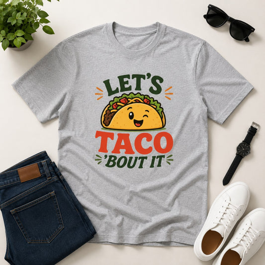 Men's grey cotton T-shirt featuring a cute smiling taco graphic with the funny phrase "Let's Taco 'Bout It".