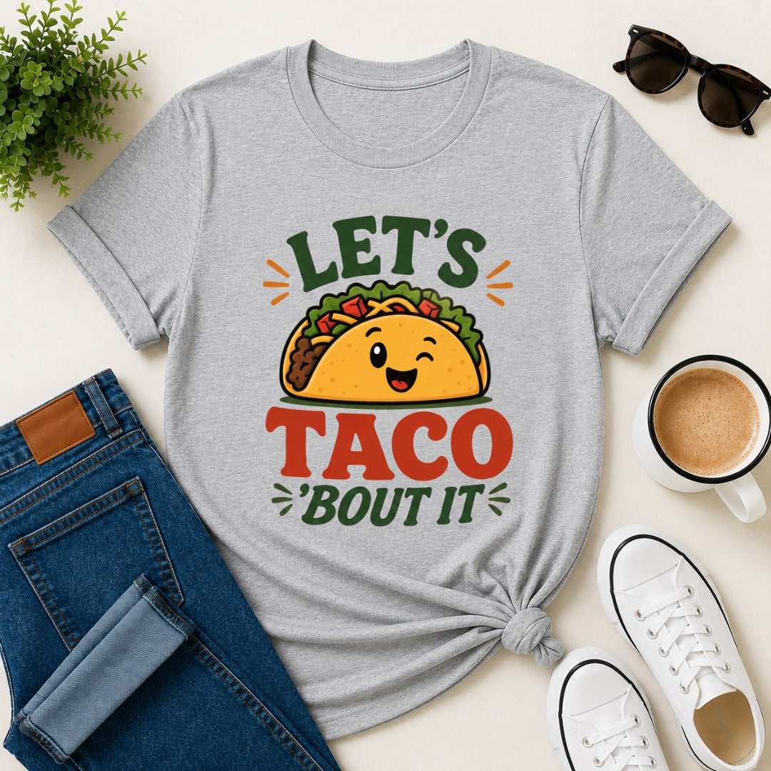 Women's gray cotton T-shirt featuring a cute smiling taco illustration and the funny phrase "Let's Taco 'Bout It".