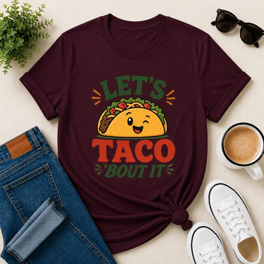 Women's maroon cotton T-shirt featuring a cute smiling taco illustration and the funny phrase "Let's Taco 'Bout It".
