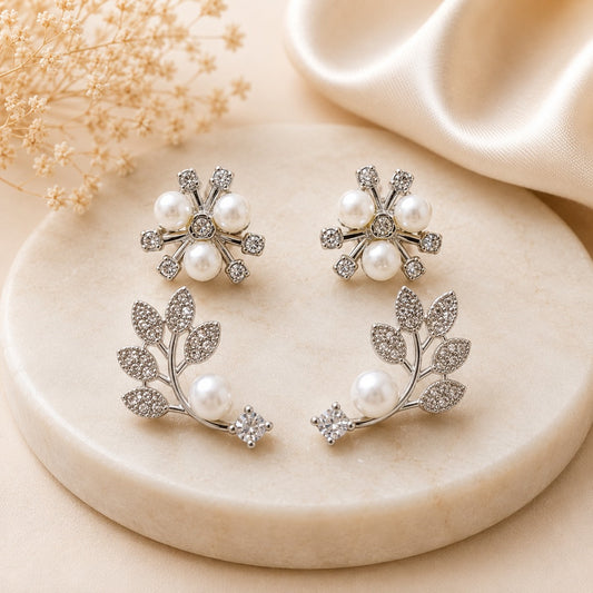 Elegant silver pearl floral and leaf stud earrings set for women with two pairs featuring crystal embellished flower and vine designs.