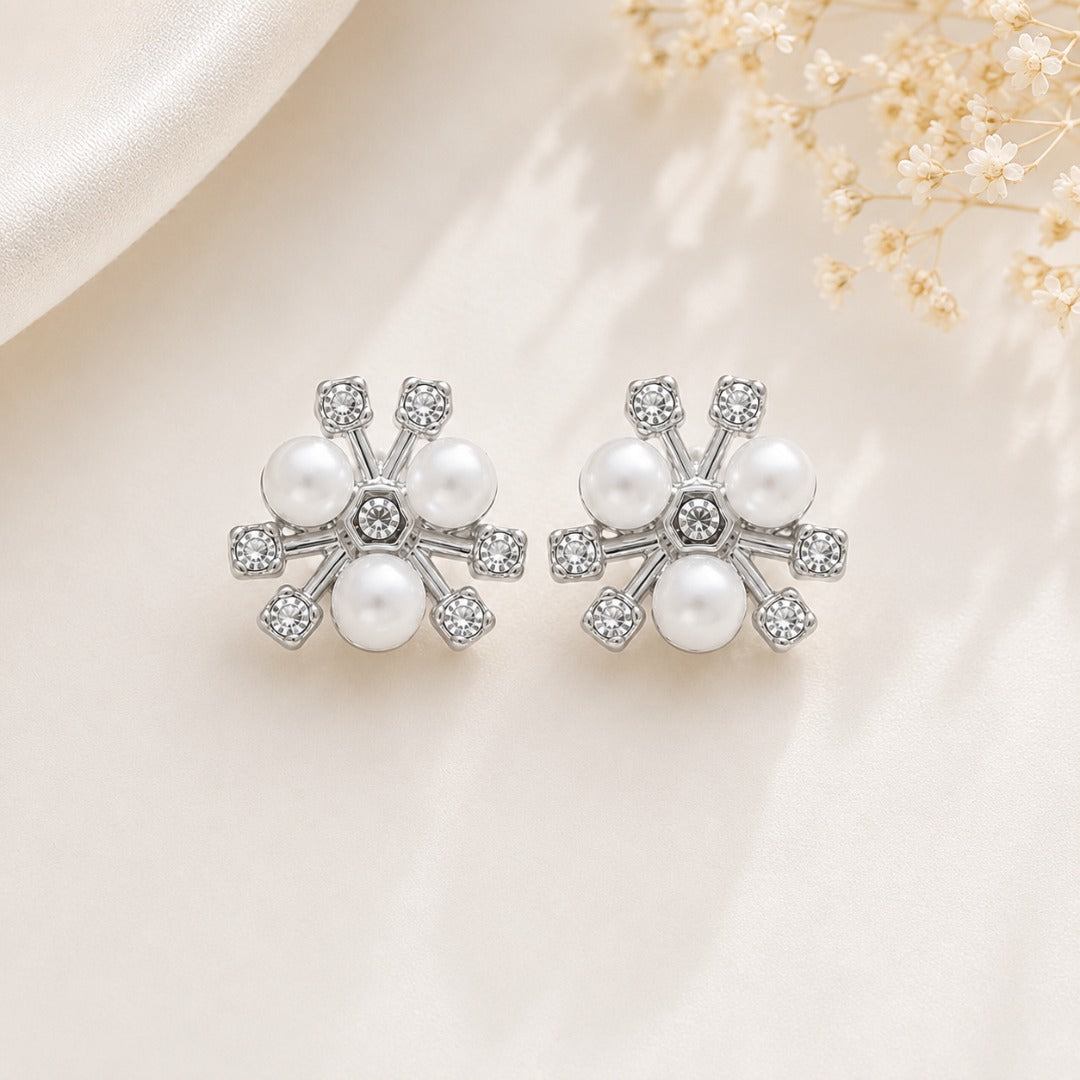 Close-up of silver pearl flower stud earrings with crystal accents for women featuring a classic floral design.