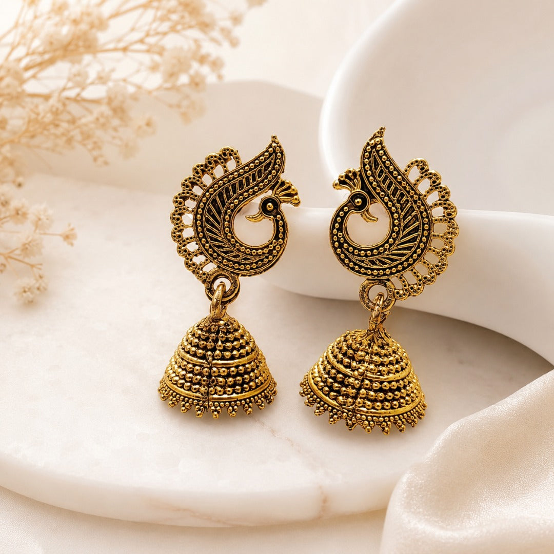 Close-up of traditional peacock jhumka earrings for festive and ethnic wear