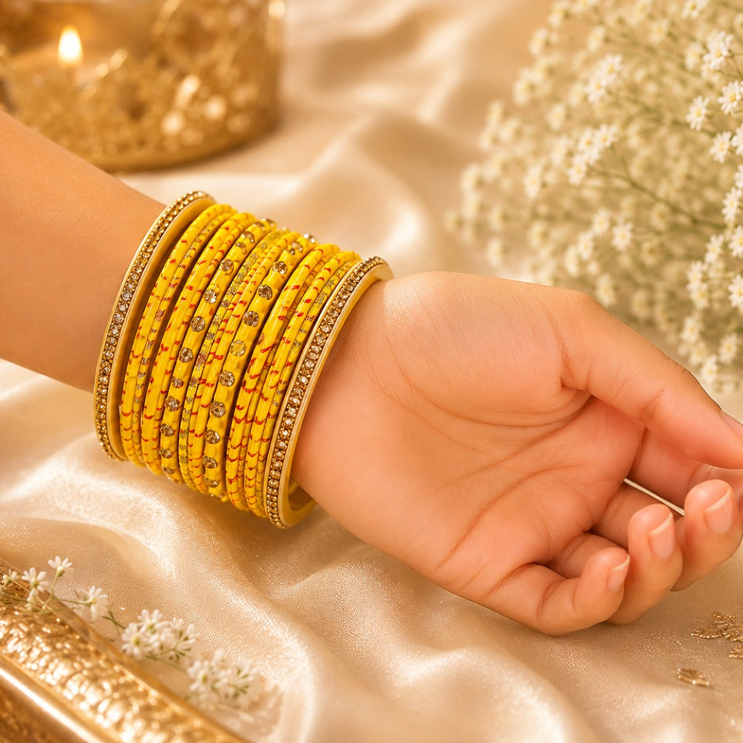 Close-up of yellow traditional lac bangles worn on a woman's hand.